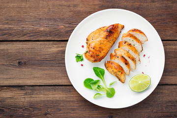Grilled chicken breast. Sliced chicken fillet with lime.
