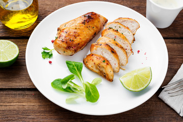 Grilled chicken breast. Sliced chicken fillet with lime.