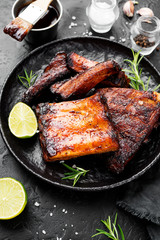 Grilled and smoked pork ribs with barbeque sauce and rosemary.