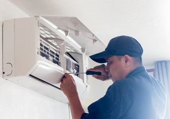  technician working service  air conditioner inroom