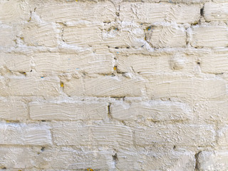 Gray brick wall background. Old brick wall horizontal texture. The brick wall is covered with plaster. Stone wallpaper. Antique brickwork with uneven plaster. Retro Grunge Wall.