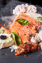 Closeup Salmon steak fillet with eggs and vegetables. Restaurant menu, a series of photos of different dishes