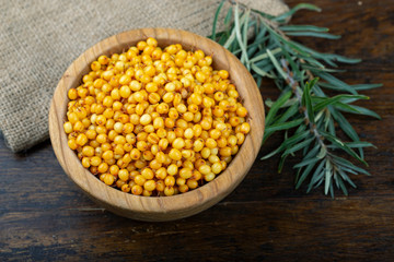 raw sea buckthorn on a wooden background