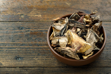 dry mushrooms on a wooden background