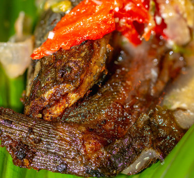 Botok lele, fried catfish served with spicy curry and wrapped with banana leaf. Javanese traditional cuisine