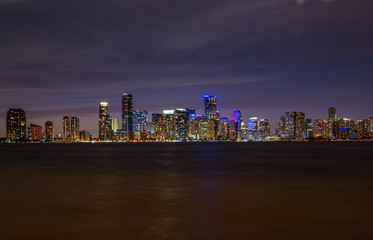Miami, Florida, USA skyline. View from on Biscayne Bay. Night in the beautiful city of Miami. Skyscrapers in Miami Downtown. Tropical night near the ocean in Florida. City Lights.