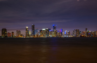 Fototapeta premium Miami, Florida, USA skyline. View from on Biscayne Bay. Night in the beautiful city of Miami. Skyscrapers in Miami Downtown. Tropical night near the ocean in Florida. City Lights.