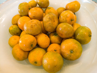 small yellow oranges on a plate