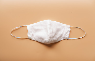 homemade cloth masks for protection against coronavirus (COVID-19) on brown background medium shot