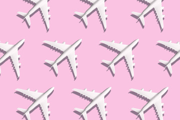 Creative banner of white planes on pink background. Travel, vacation concept. Travel, vacation ban. Flights cancelled and resumed again. Top view. Flat lay. Minimal style design. Summer pattern.