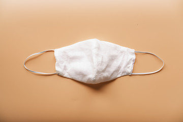 homemade cloth masks for protection against coronavirus (COVID-19) on brown background medium shot