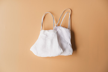 homemade cloth masks for protection against coronavirus (COVID-19) on brown background medium shot