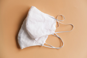 homemade cloth masks for protection against coronavirus (COVID-19) on brown background medium shot