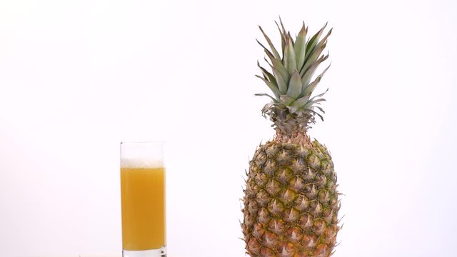  Fresh Pineapple Juice and Pineapple Rotating On A White Background