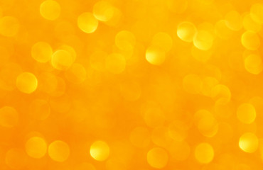 Abstract blurry orange gold yellow bokeh background.  