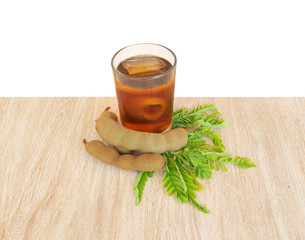 Cold tamarind juice on a brown wooden table