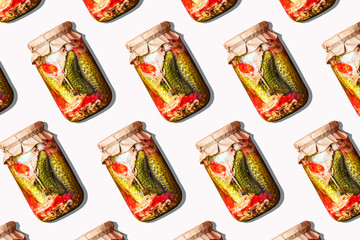 Canned and preserved vegetables in glass jars on white background. Pickled cucumbers in jar pattern. Top view. Flat lay. Creative packing design. Healthy fermented food concept