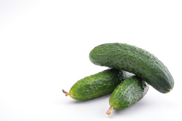 green cucumbers on a white isolated background, free space
