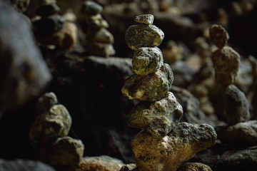 Balancing stones tower on mossy stone background