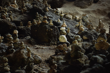 Balancing stones tower on mossy stone background