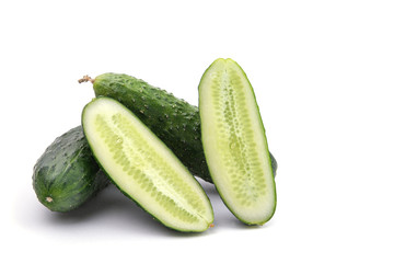 cucumbers whole and cut on a white isolated background close-up