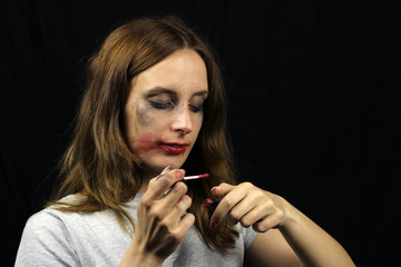 Crazy drunk girl with smeared mascara smears lipstick