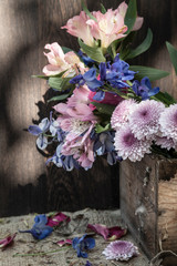 Romantic vintage retro look applied to flower and garden paraphenalia still life image with Spring and Summer seasonal blooms