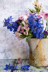 Romantic vintage retro look applied to flower and garden paraphenalia still life image with Spring and Summer seasonal blooms
