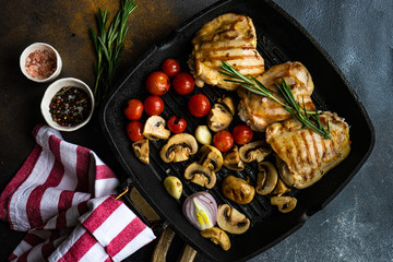 Grilled chicken and vegetable on stone background