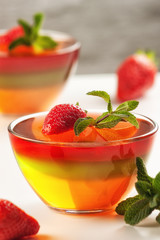 Fruit jelly with strawberries on a white table