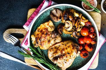 Grilled chicken and vegetable on stone background