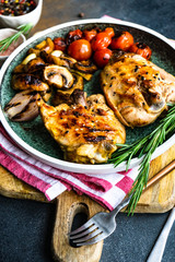 Grilled chicken and vegetable on stone background