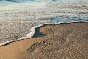 Footprints in send on a beach. Freelance workplace. White sand on the beach of luxury hotel, sunny...
