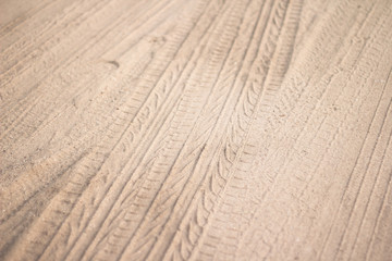 motorcycle and car tire track print on sand or mud with selective focus