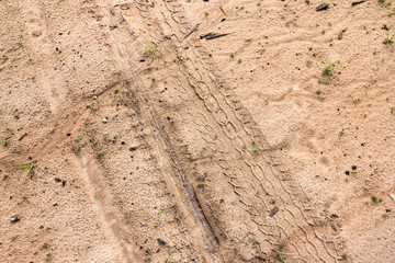 motorcycle and car tire track print on sand or mud with selective focus