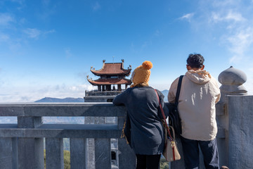 Tourist enjoy with landscape view at Fansipan peak mountain, there are temple and buddha statue on the top famous place for travel in Sapa city, Vietnam.