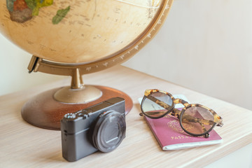 globe, digital camera,sun glasses,ticket airplane and passport on a wooden table. Idea, photo tourism, adventure, travel around the world