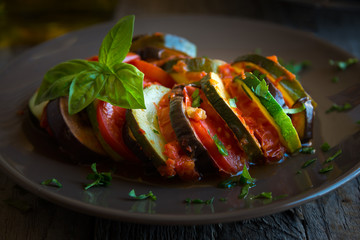 Homemade ratatouille made with sliced vegetables: zucchini, tomatoes and eggplant. Delicious vegan...