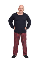 Fototapeta premium man in pajamas on white background, hands on hip
