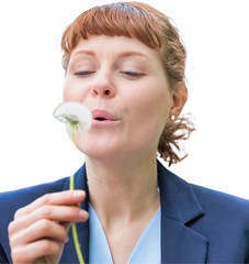 Cutout of young attractive businesswoman wishing on dandelion