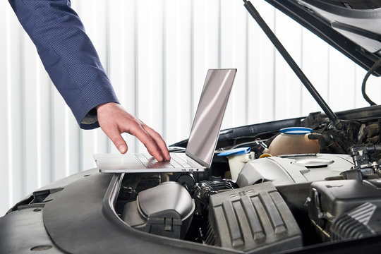 Car Mechanic Using Computer In Auto Repair Shop