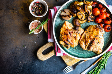 Grilled chicken and vegetable on stone background