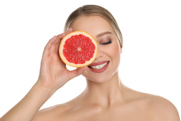 Young woman with cut grapefruit on white background. Vitamin rich food