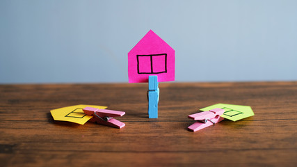 Paper houses on desk - Real estate, housing project concept. 