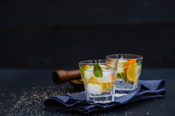 Gin and tonic cocktail with lemon and mint