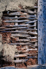 Old type of building construction of walls,wattle and daub mud straw and stick method.