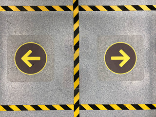 Yellow arrow sign on the floor with black and yellow stripes to keep distance of the standing in elevator