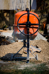 Orange cement mixer on building site