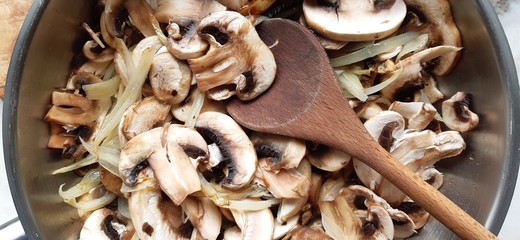 Close up of chopped mushrooms in a frying pan