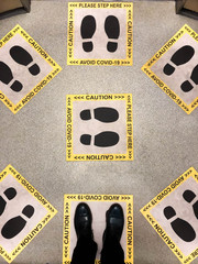 Footprint sign in the elevator for the social distancing to avoid the spread of Virus Covid-19
